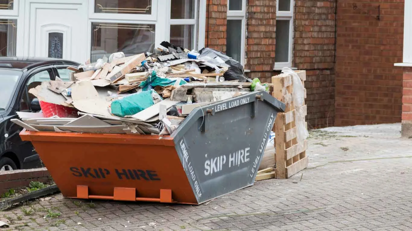 Yellow skip bin placed on a Cardiff driveway for budget-friendly household waste removal